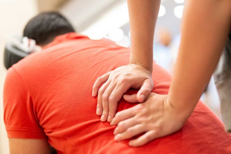 A person discussing a wellness plan with a chiropractor in a comfortable clinic setting.